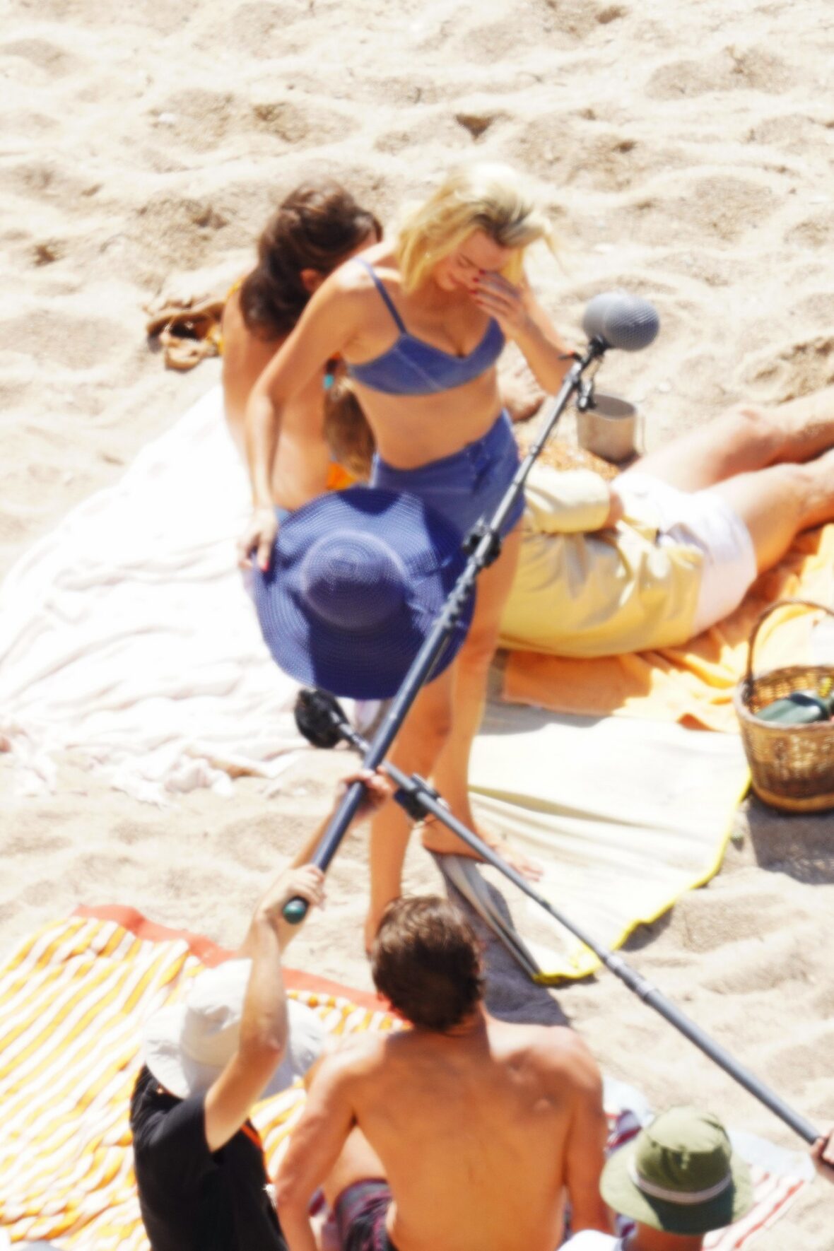 Margot Robbie and Bradley Cooper in swimsuits on beach for Ocean's Eleven prequel movie