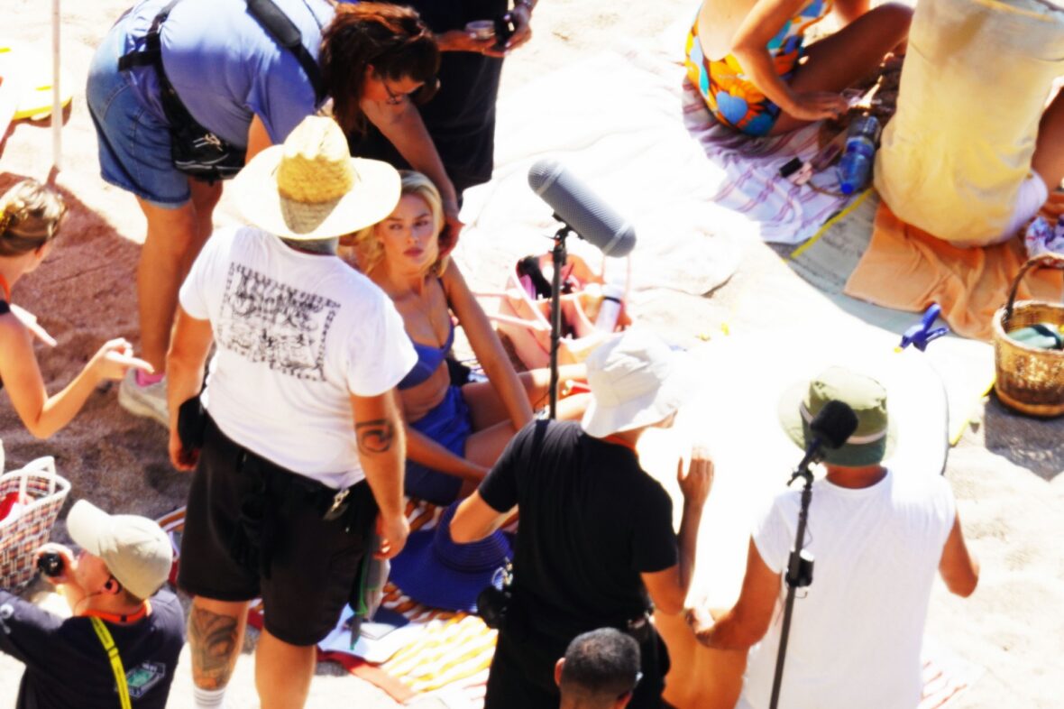 Margot Robbie and Bradley Cooper in swimsuits on beach for Ocean's Eleven prequel movie