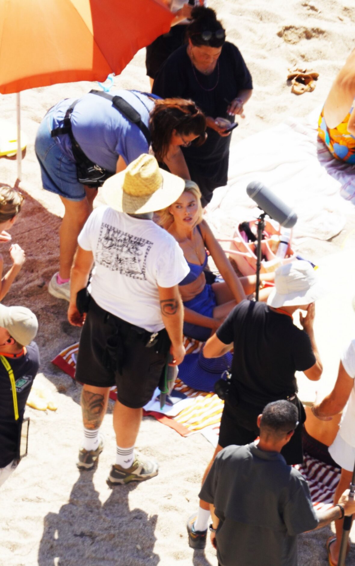 Margot Robbie and Bradley Cooper in swimsuits on beach for Ocean's Eleven prequel movie
