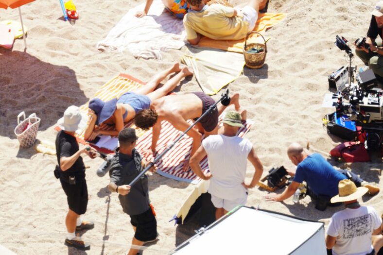 Margot Robbie and Bradley Cooper in swimsuits on beach for Ocean's Eleven prequel movie