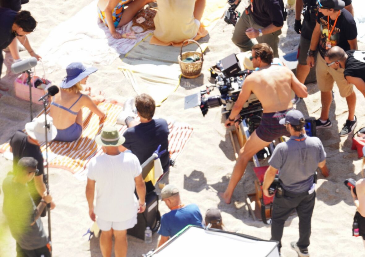 Margot Robbie and Bradley Cooper in swimsuits on beach for Ocean's Eleven prequel movie