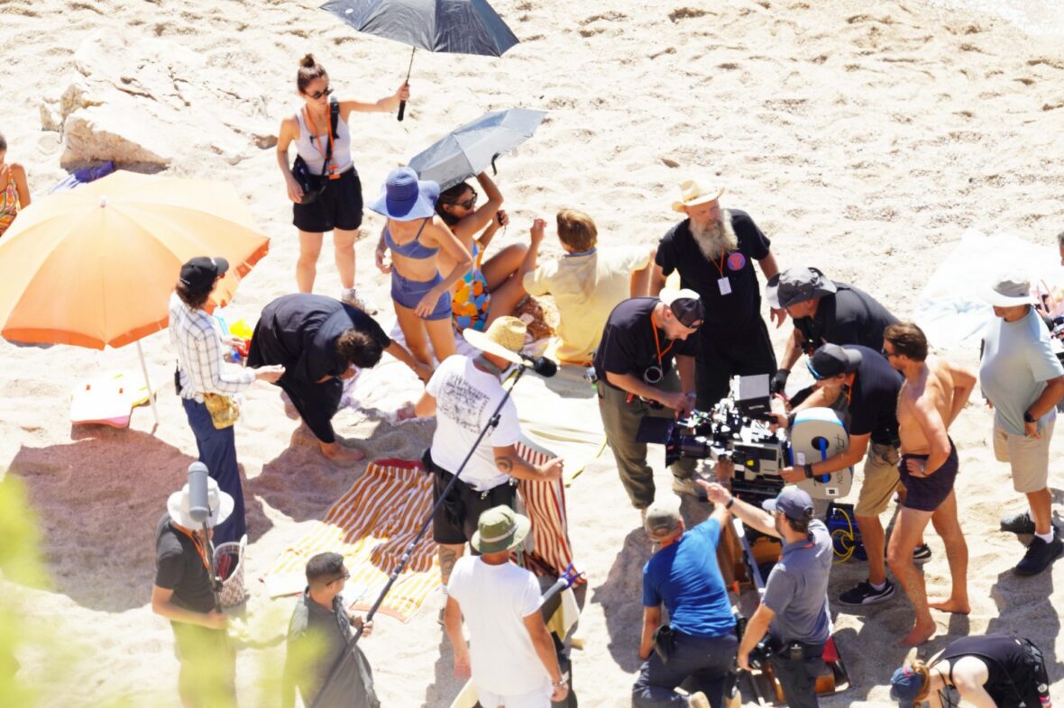 Margot Robbie and Bradley Cooper in swimsuits on beach for Ocean's Eleven prequel movie