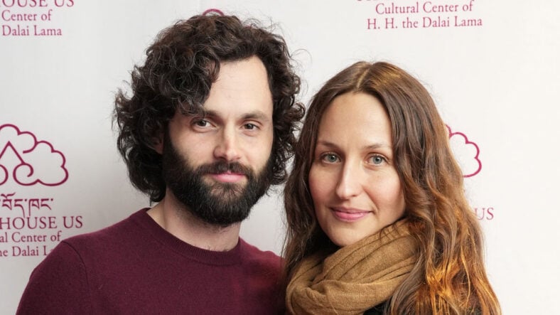 Penn Badgley and Domino Kirke during a 2022 appearance in a stock photo
