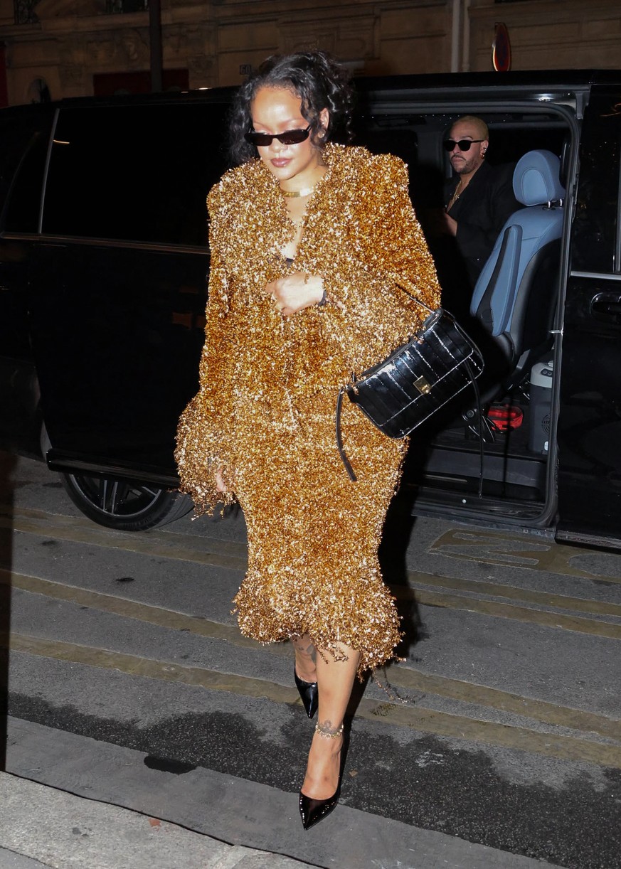 Rihanna in a gold embellished skirt suit.