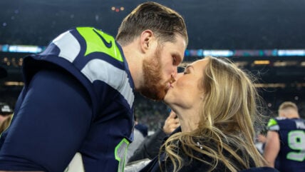 Sam Darnold and his now-wife Katie kissing at the NFC Championship game in 2026
