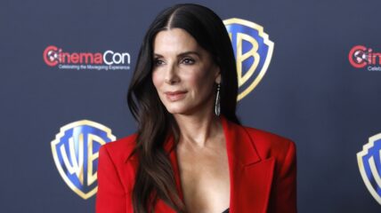 Sandra Bullock in red looking to the side