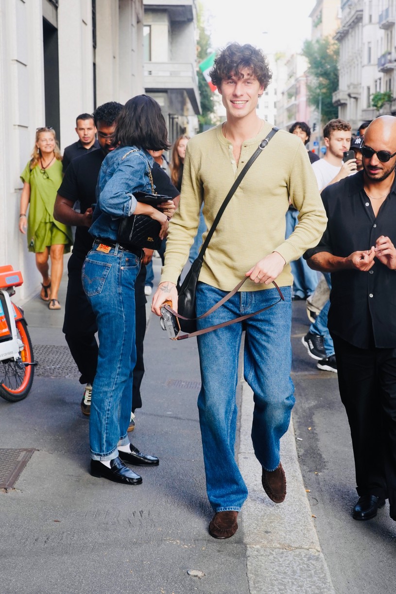 Shawn Mendes in a long-sleeve top with a camera in Milan alongside girlfriend Bruna Marquezine who is dressed in all denim.