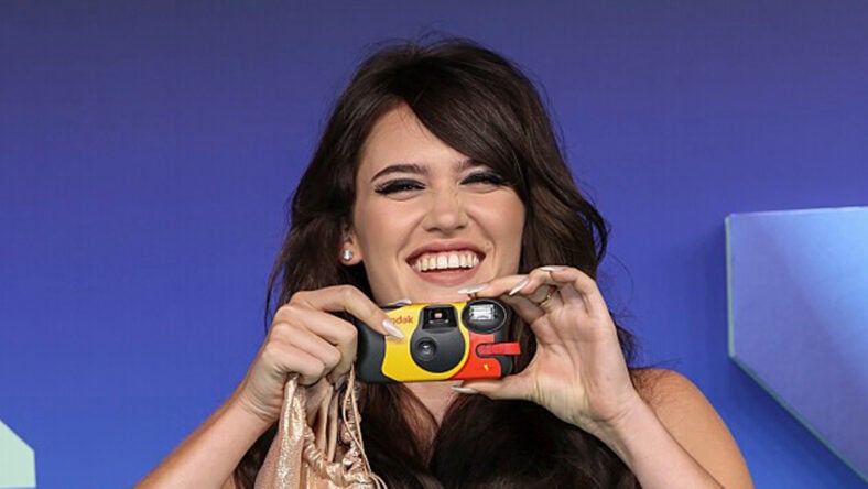 Sienna Spiro holding a camera