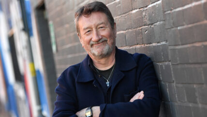 Steven Knight leaning against wall