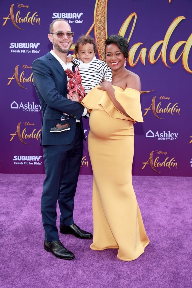 Tatyana Ali and husband Vaughn Rasberry pose with their son at the live-action Aladdin premiere