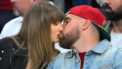 Travis Kelce and Taylor Swift kissing at the NBA finals