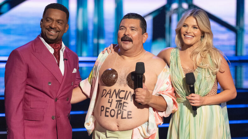 Witney Carson and Guillermo Rodriguez get their scores from the judges with host Alfonso Ribiero holding a microphone