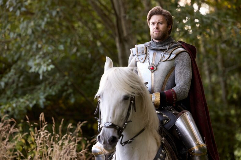James Trevena riding a horse in a knight costume in a still from A Knight to Remember.