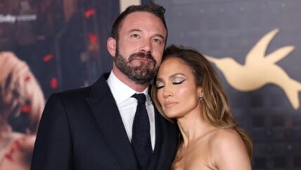 Ben Affleck and Jennifer Lopez embracing on red carpet