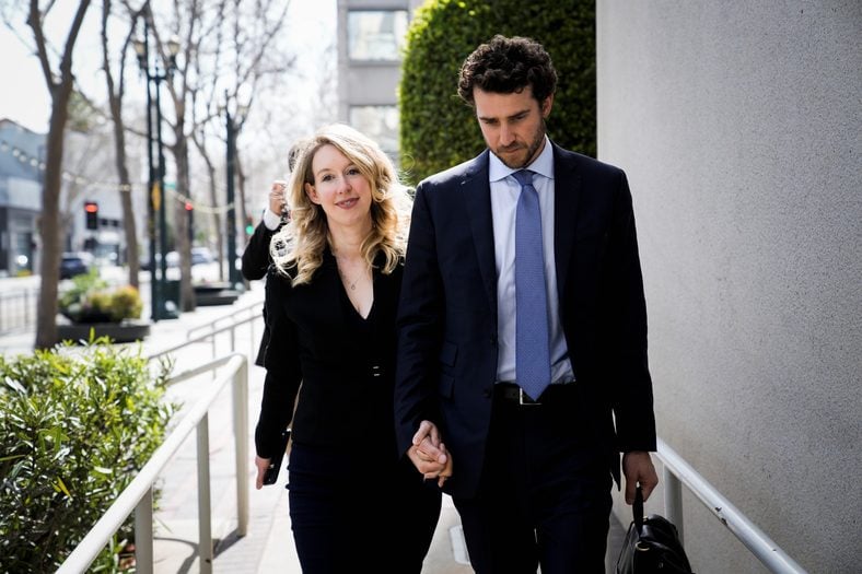 Elizabeth Holmes and Billy Evans leave a court hearing
