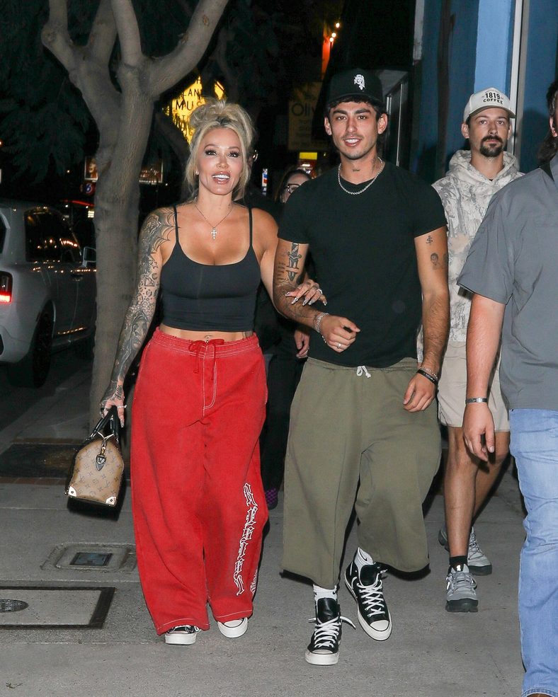 Bunnie XO and Dylan Wolf link arms while arriving for dinner in Sherman Oaks