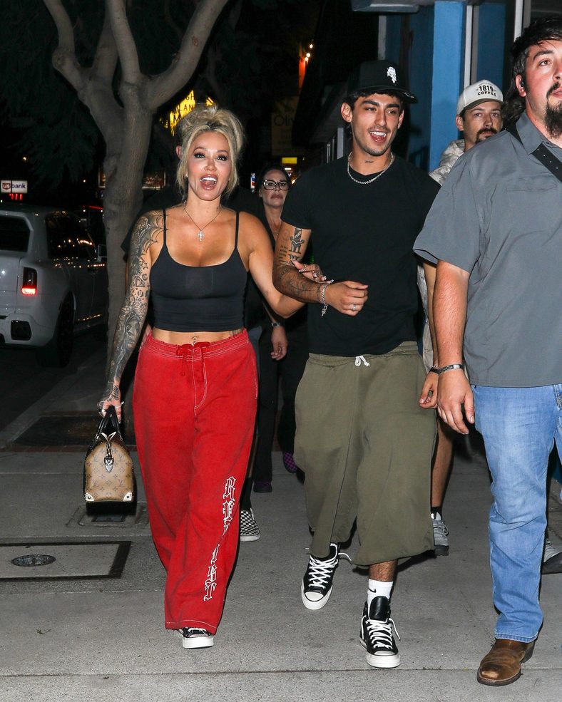 Bunnie XO and Dylan Wolf link arms while arriving for dinner in Sherman Oaks