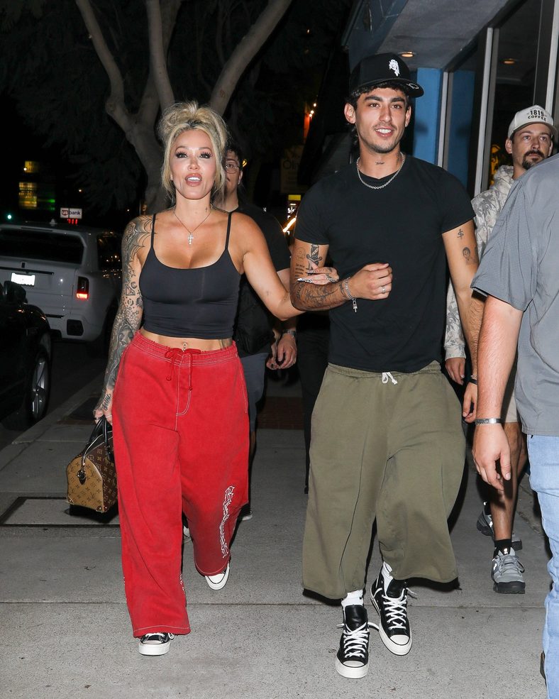 Bunnie XO and Dylan Wolf link arms while arriving for dinner in Sherman Oaks