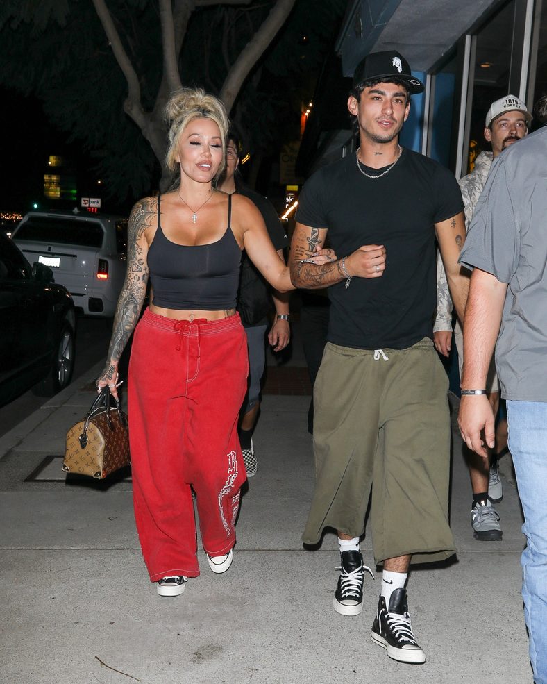 Bunnie XO and Dylan Wolf link arms while arriving for dinner in Sherman Oaks