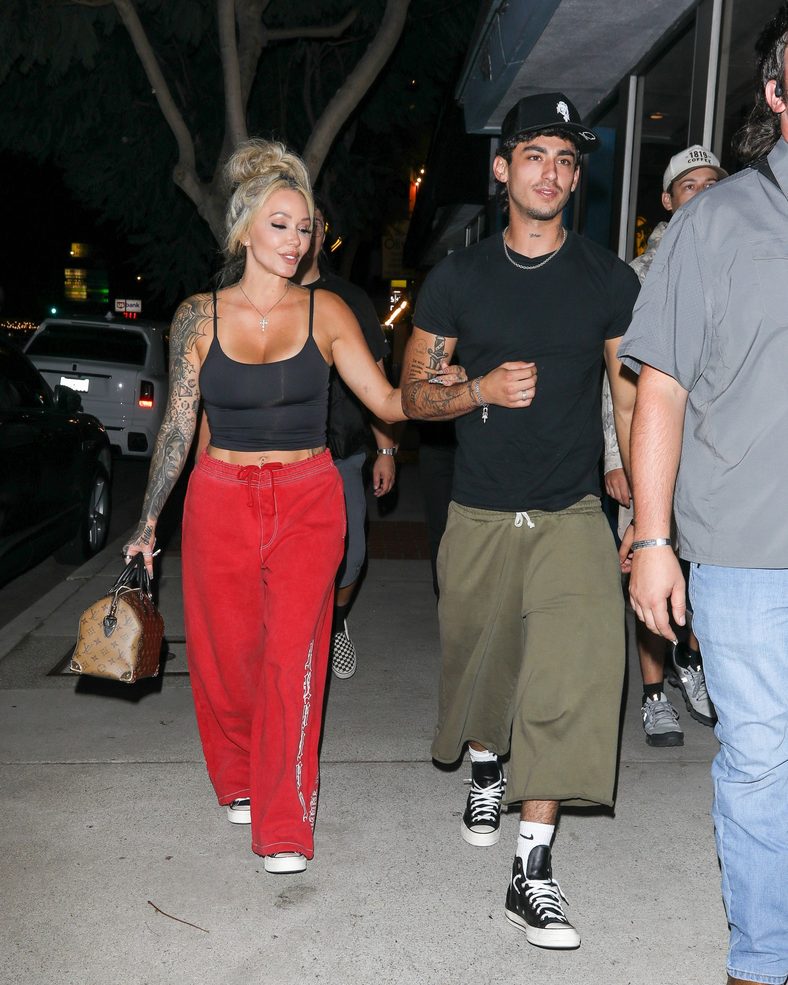 Bunnie XO and Dylan Wolf link arms while arriving for dinner in Sherman Oaks