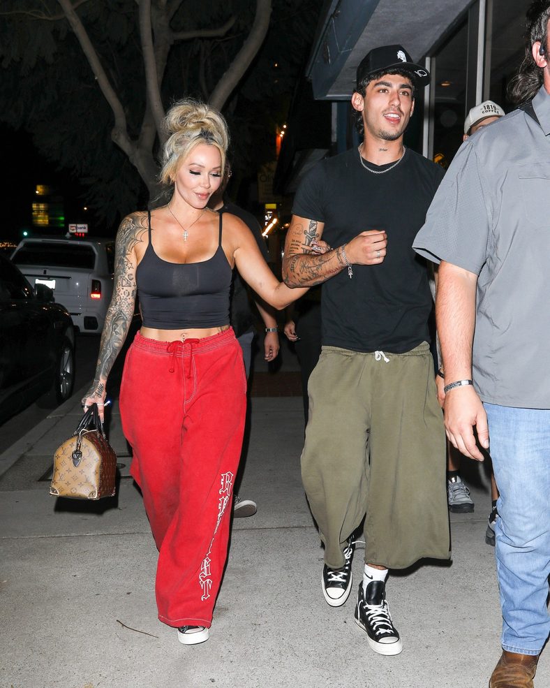 Bunnie XO and Dylan Wolf link arms while arriving for dinner in Sherman Oaks