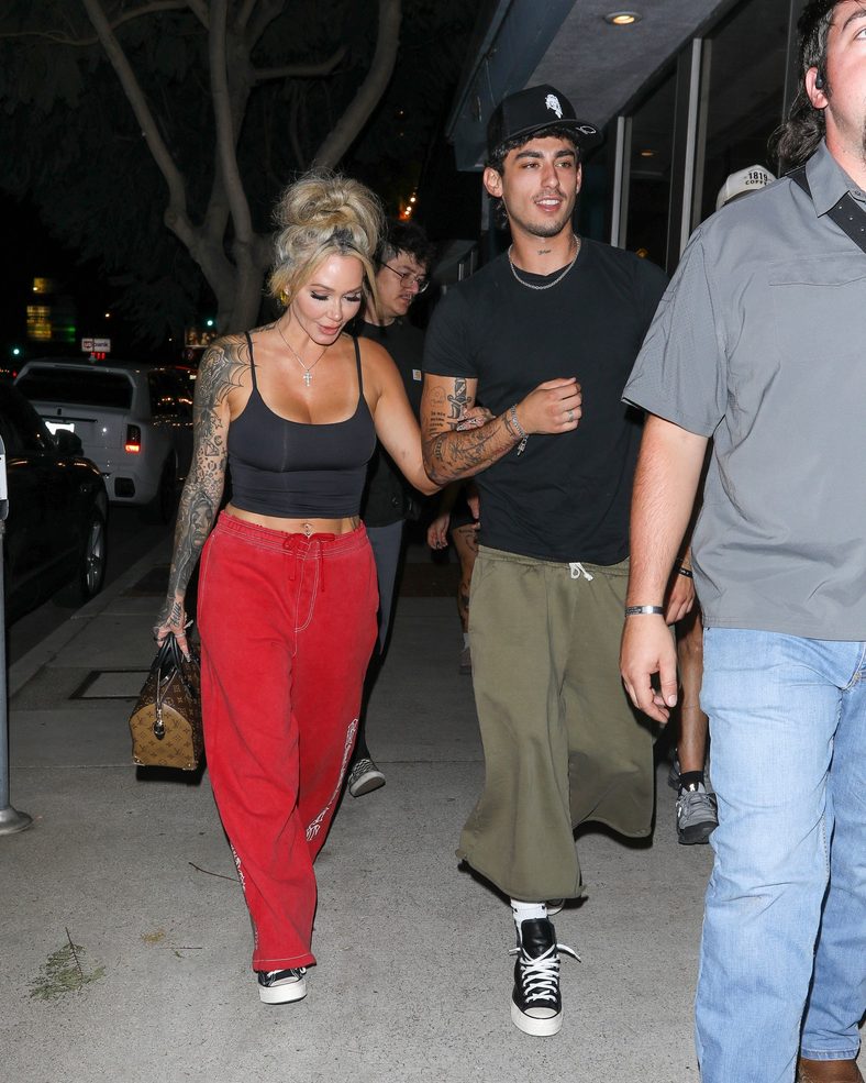 Bunnie XO and Dylan Wolf link arms while arriving for dinner in Sherman Oaks
