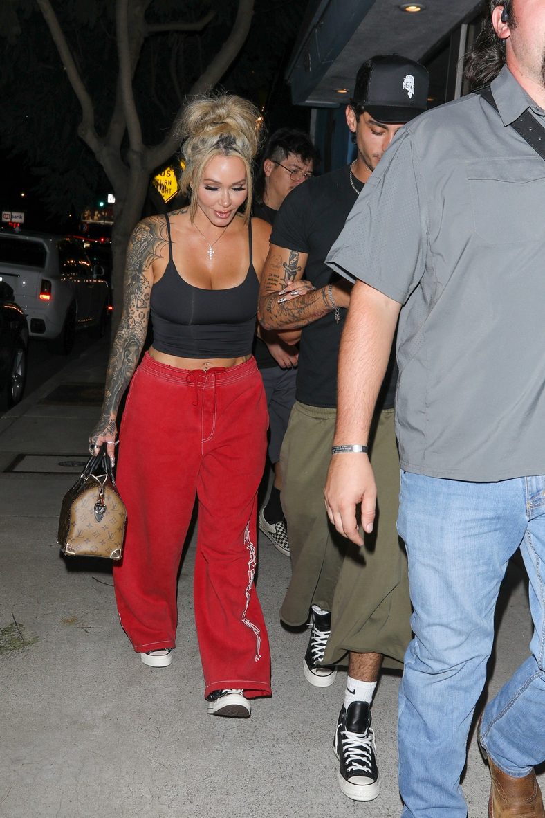Bunnie XO and Dylan Wolf link arms while arriving for dinner in Sherman Oaks