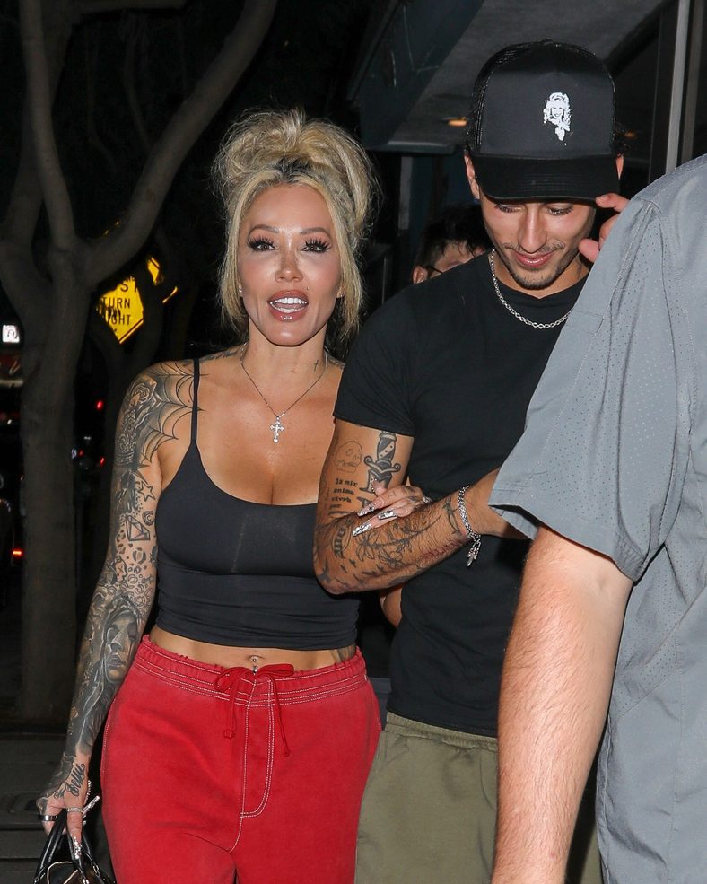 Bunnie XO and Dylan Wolf link arms while arriving for dinner in Sherman Oaks