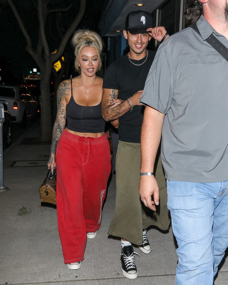 Bunnie XO and Dylan Wolf link arms while arriving for dinner in Sherman Oaks