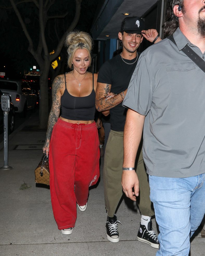 Bunnie XO and Dylan Wolf link arms while arriving for dinner in Sherman Oaks