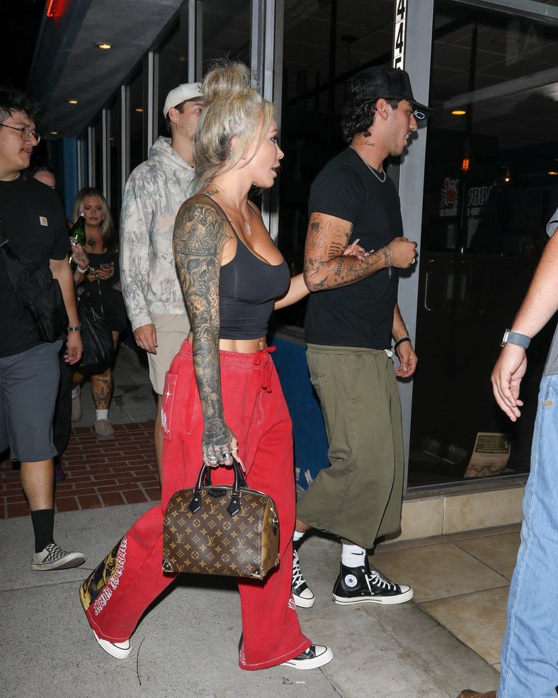 Bunnie XO and Dylan Wolf link arms while arriving for dinner in Sherman Oaks