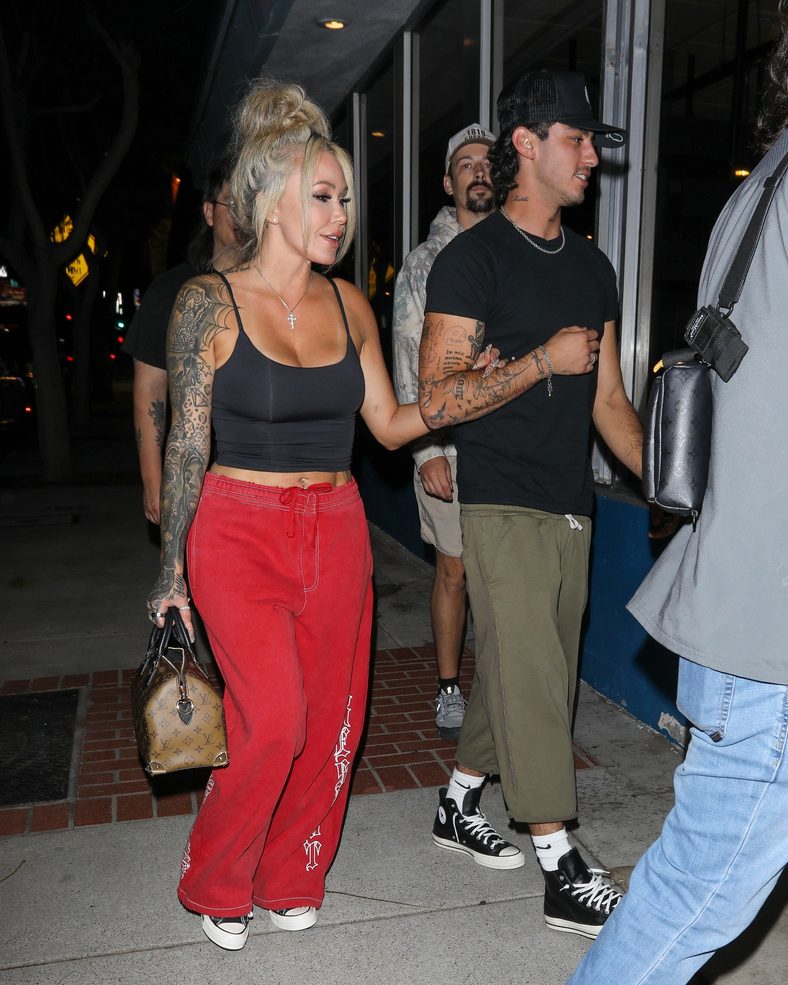 Bunnie XO and Dylan Wolf link arms while arriving for dinner in Sherman Oaks