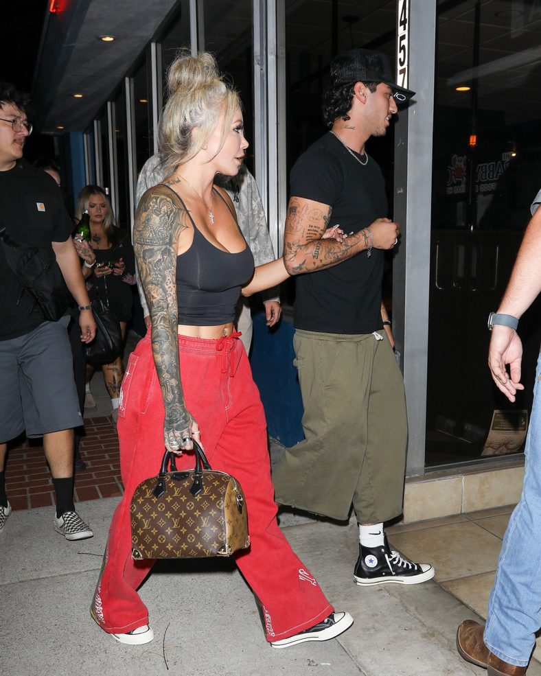Bunnie XO and Dylan Wolf link arms while arriving for dinner in Sherman Oaks