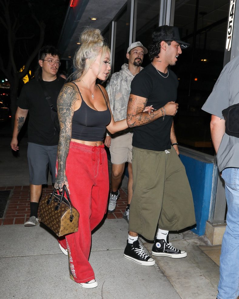 Bunnie XO and Dylan Wolf link arms while arriving for dinner in Sherman Oaks