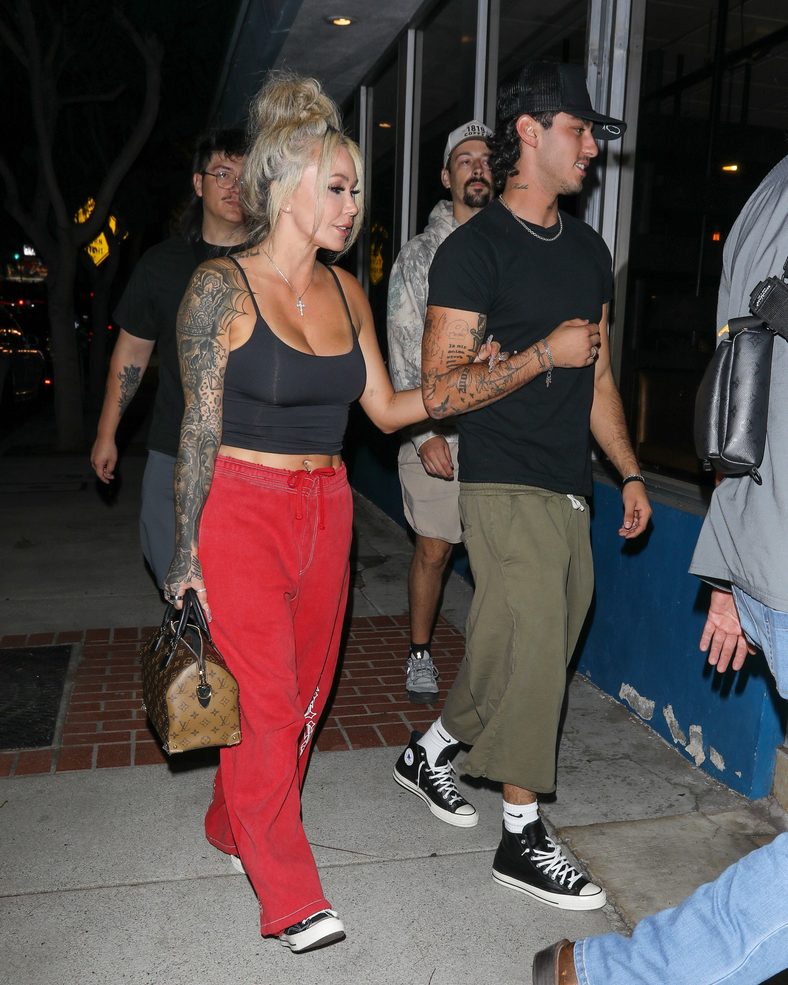 Bunnie XO and Dylan Wolf link arms while arriving for dinner in Sherman Oaks