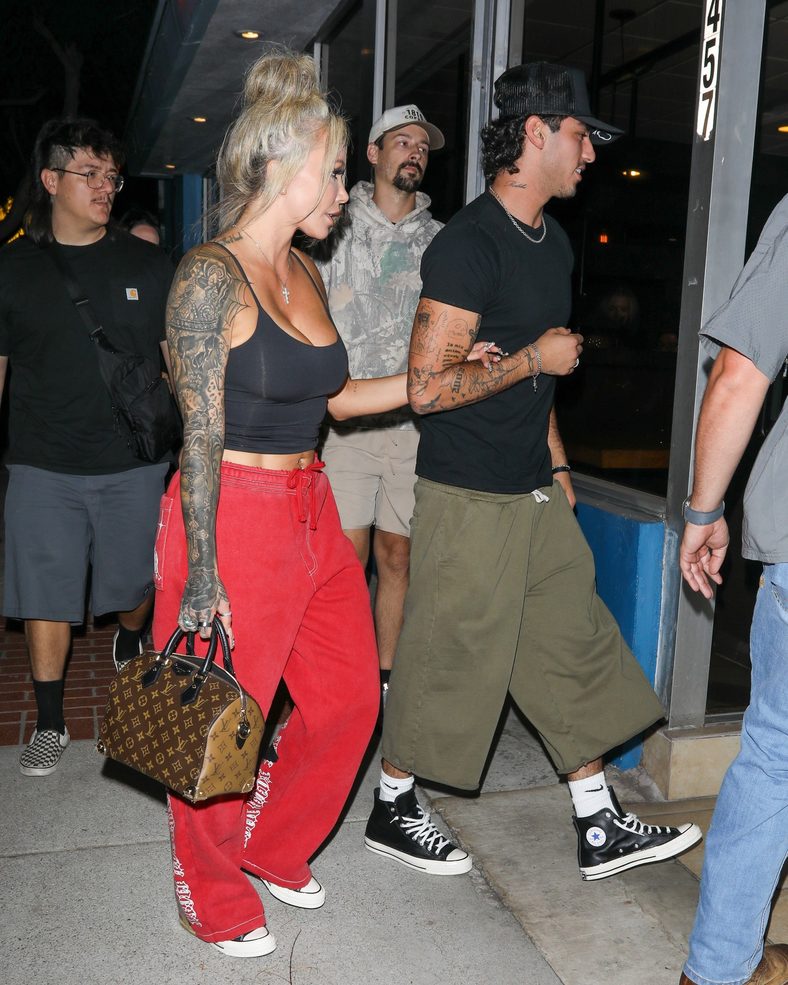 Bunnie XO and Dylan Wolf link arms while arriving for dinner in Sherman Oaks