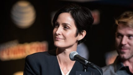 Carrie Ann Moss speaking at microphone
