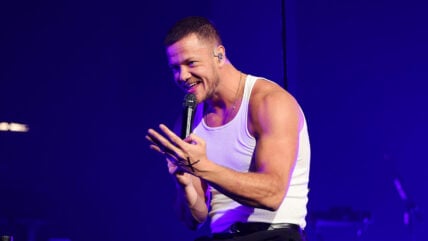 Dan Reynolds shows off his muscles