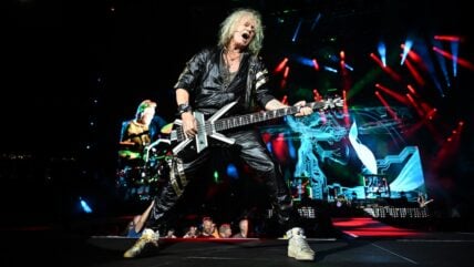 Rick Savage of Def Leppard performs onstage during the "Summer Stadium" tour at Truist Park on July 13, 2024 in Atlanta, Georgia