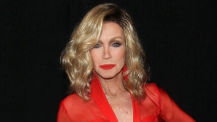 Donna Mills posing in red