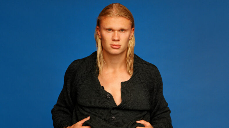 Erling Haaland poses in a black outfit with a blue backdrop for WSJ Magazine