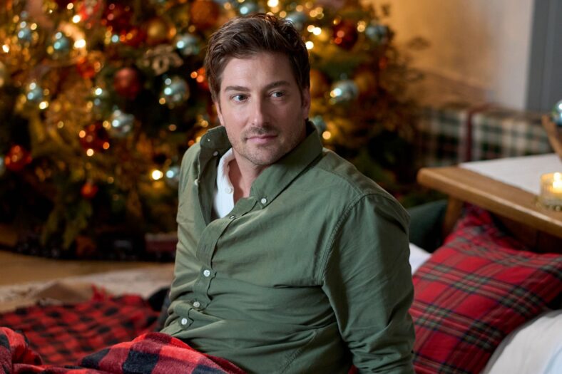 Daniel Lissing in a green long-sleeve shirt in a still from Forgotten Holiday.