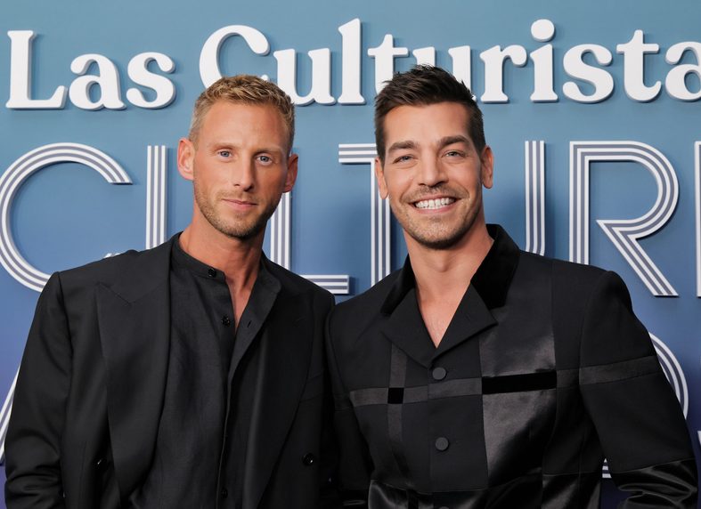 Fraser Olender and Matt Rogers hold hands on the carpet at the 2026 Las Culturistas Culture Awards