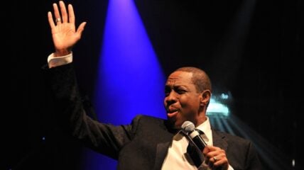 Freddie Jackson performing on stage with microphone