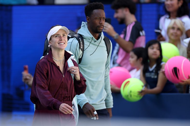 Gael Monfils of France walks out with Elina Svitolina of Ukraine in their mixed doubles match during Fan Week at the USTA Billie Jean King National Tennis Center on August 25, 2026 in the Flushing neighborhood of the Queens borough of New York City