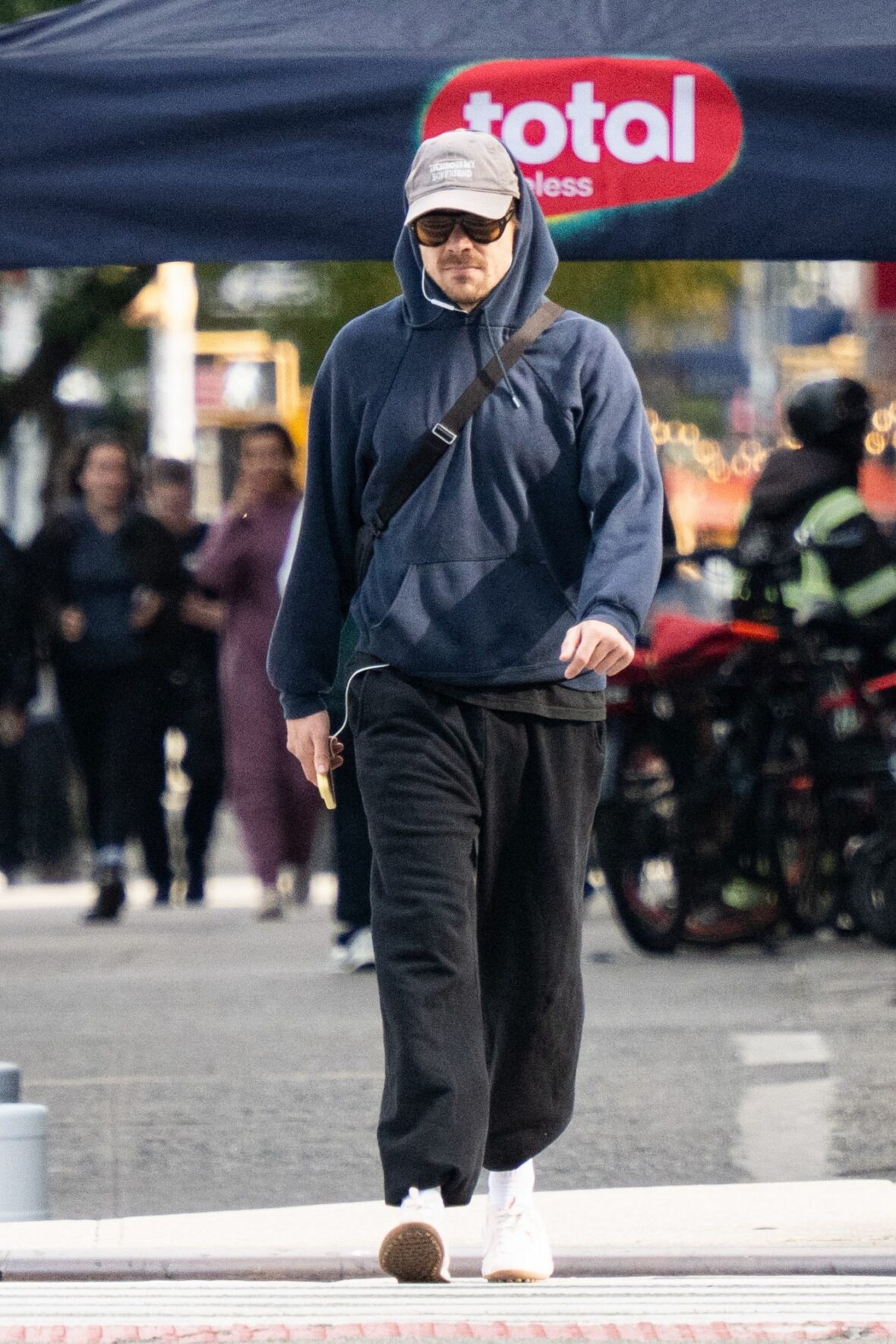 Harry Styles gets followed by an autograph seeker on the streets of New York City