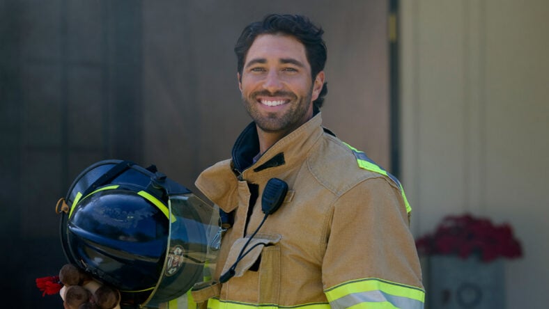 Joey Graziadei as a fireman in The Holiday Spark movie on Roku