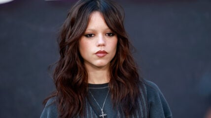 Jenna Ortega in a dark green sweater.