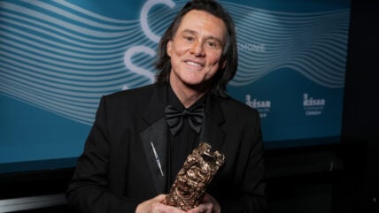 Jim Carrey holding his Cesar Award.