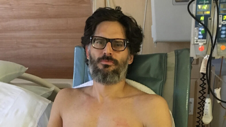 Joe Manganiello sitting shirtless in a hospital bed